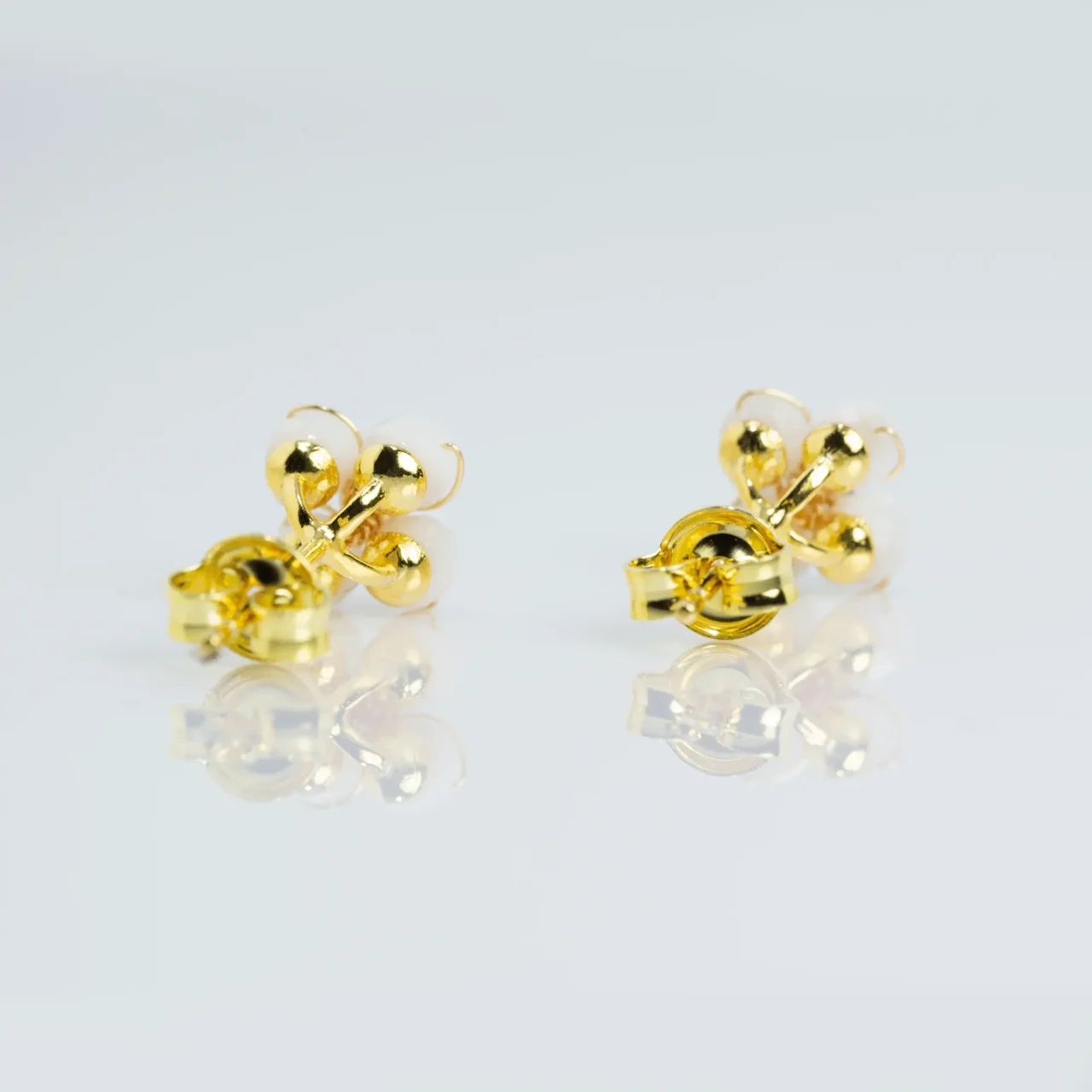 Stylish White Shell flower stud earrings with gold accents, gemstones