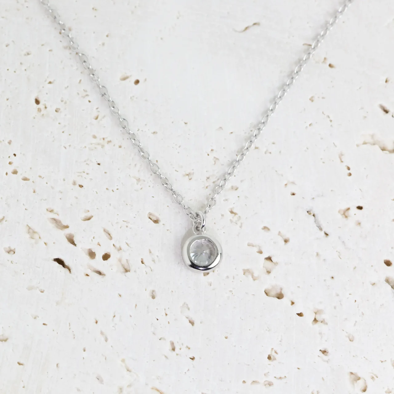 Elegant silver necklace with a sparkling round pendant